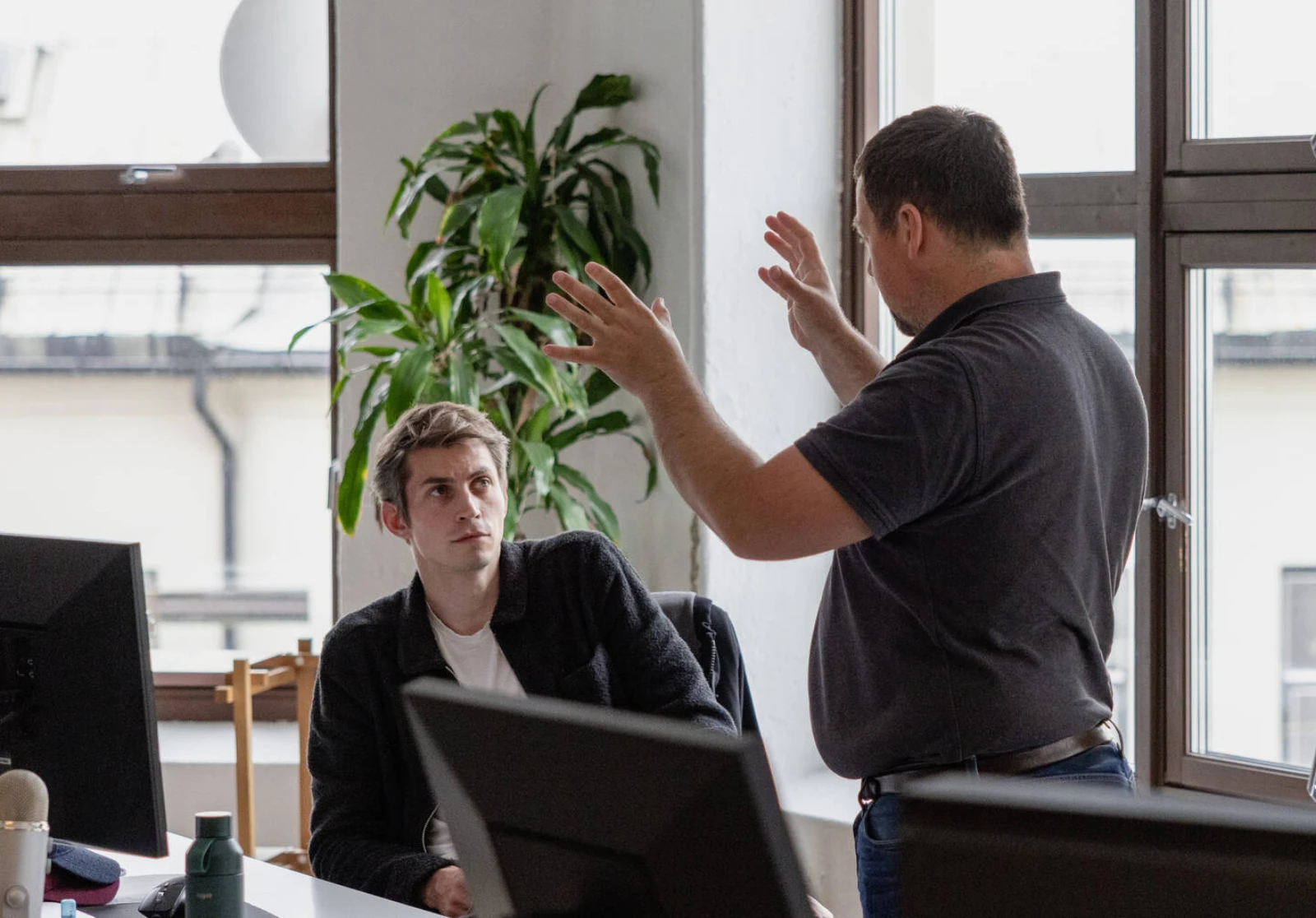 Two people gesturing in a lively discussion